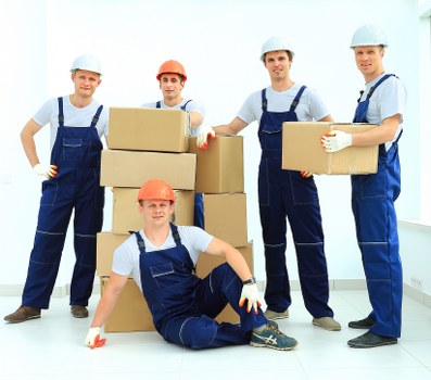 Local movers handling boxes and desks in a commercial relocation