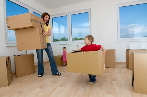 Professional movers unloading boxes at a White City home