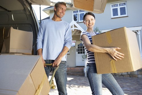 Professional movers handling office furniture in a White City business premises