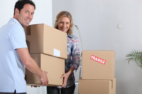 Packed moving boxes and furniture ready for collection in White City